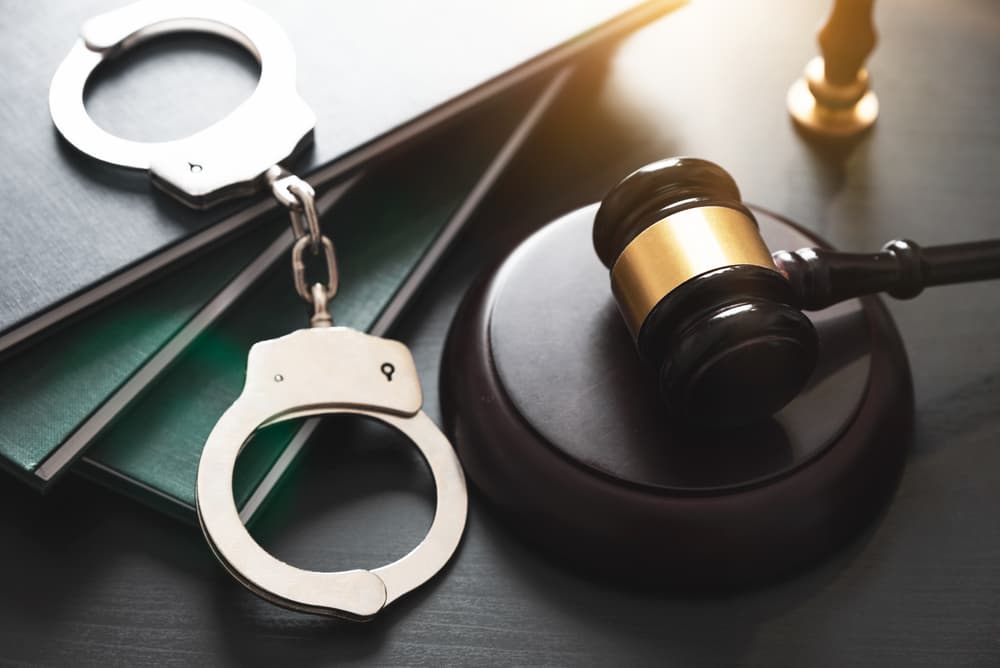 Handcuffs and wooden gavel.
