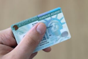 person holding green card