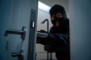 Thief in uniform black jacket various action housebreak. 